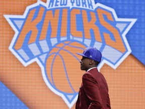 Frank Ntilikina walks up on stage after being selected by the New York Knicks as the eighth pick overall during the NBA basketball draft, Thursday, June 22, 2017, in New York. (AP Photo/Frank Franklin II)