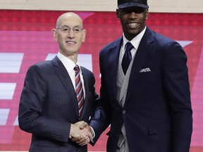 Bam Adebayo, right, poses for photos with NBA Commissioner Adam Silver after being selected by the Miami Heat as the 14th pick overall during the NBA basketball draft, Thursday, June 22, 2017, in New York. (AP Photo/Frank Franklin II)