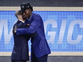 Jonathan Isaac, right, is greeted by NBA Commissioner Adam Silver after being selected by the Orlando Magic as the sixth pick overall during the NBA basketball draft, Thursday, June 22, 2017, in New York. (AP Photo/Frank Franklin II)