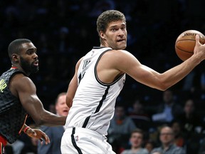 FILE - In this April 2, 2017, file photo, Brooklyn Nets center Brook Lopez drives to the basket past Atlanta Hawks guard Tim Hardaway Jr. during an NBA basketball game in New York. Three people with knowledge of the deal say the Los Angeles Lakers have agreed to trade point guard D'Angelo Russell and high-priced center Timofey Mozgov to the Nets for big man Lopez and the 27th overall pick in the upcoming draft. The people spoke to The Associated Press on condition of anonymity because the trade hadn't been consummated Tuesday, June 20. (AP Photo/Adam Hunger, File)