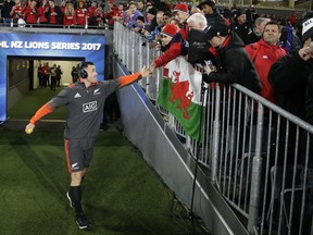 All Blacks Ryan Crotty gestures with fans as he walks out onto the field ahead of the first test between the British and Irish Lions and the All Blacks at Eden Park in Auckland, New Zealand, Saturday, June 24, 2017. (AP Photo/Mark Baker)