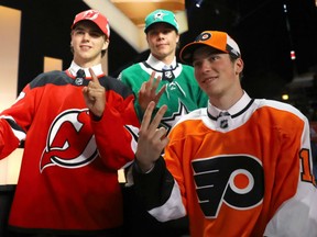 The top three picks in Friday's NHL entry draft, from left, Nico Hischier (No. 1), Miro Heiskanen (No. 3) and Nolan Patrick (No. 2) pose with their respective team jerseys at the United Center in Chicago.