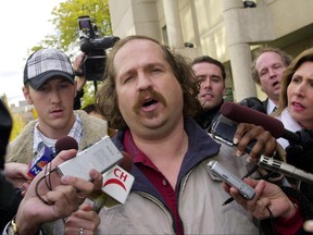 In this Thursday, Oct. 23, 2003, file photo, Kirk Jones of Canton, Mich., the man who survived a plunge over Niagara Falls, talks to reporters after being released from custody in St. Catherines, Ontario. Jones, who died after plunging over Niagara Falls in an apparent stunt with an inflatable ball might have brought a boa constrictor along for the ride, the Niagara Gazette reported Wednesday, June 28, 2017, that police found a website with a photo of Jones and the snake previewing Jones' plans. An unoccupied large plastic ball he apparently planned to ride over the falls was found empty below the falls in April