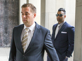 Toronto police officers Leslie Nyznik and Sameer Kara arrive at court on June 5, 2017. They along with fellow officer Joshua Cabero are accused of sexual assault on a female colleague.