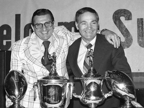 FILE - In this Dec. 24, 1977, file photo, Penn State's Joe Paterno, left, and Arizona State's Frank Kush, pose for pictures at the Fiesta Bowl luncheon in Phoenix. Kush, the fearsome coach who transformed Arizona State from a backwater football program into a powerhouse, has died, Arizona State confirmed, Thursday, June 22, 2017. He was 88.  (AP Photo/Lennox McLendon, File)