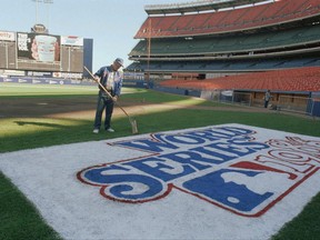 FILE - In this Oct. 24, 1986, file photo, Pete Flynn, New York Mets groundskeeper, puts the final touches on the World Series logo on the Shea Stadium field in New York, the day before Game 6 of the series. Flynn, a popular groundskeeper for the who spent five decades manicuring baseball diamonds from the Polo Grounds to Citi Field, died on Wednesday, June 21, 2017. He was 79. The team said Flynn died after a long illness. No other details were provided. (AP Photo/Susan Ragan, File)