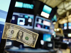 FILE - In this Thursday, Dec. 22, 2016, file photo, a dollar bill is taped to a trader's computer screen at the New York Stock Exchange. The good times keep rolling for fund investors. As of late June 2017, nearly every type of fund logged gains over the three months prior, with technology and foreign stock funds among the top performers. Even bond funds are on pace to deliver returns rivaling their best in recent years. (AP Photo/Mark Lennihan, File)