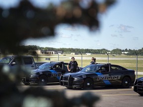 Officials evacuated the airport Wednesday, where a witness said he saw an officer bleeding from his neck and a knife nearby on the ground