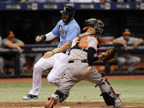 Tampa Bay Rays' Steven Souza Jr., left, beats the throw to Baltimore Orioles catcher Caleb Joseph, right, to score on Taylor Featherstone's RBI-single during the second inning of a baseball game Sunday, June 25, 2017, in St. Petersburg, Fla. (AP Photo/Steve Nesius)