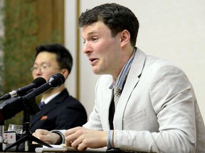 Otto Frederick Warmbier (R), who was arrested for committing hostile acts against North Korea, speaking at a press conference in Pyongyang, February 29, 2016