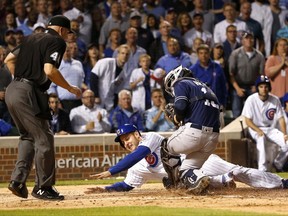 San Diego Padres catcher Austin Hedges tags out Chicago Cubs' Anthony Rizzo during a collision at home on a throw from Matt Szczur, as home plate umpire Jeff Nelson watches during the sixth inning of a baseball game Monday, June 19, 2017, in Chicago. (AP Photo/Charles Rex Arbogast)