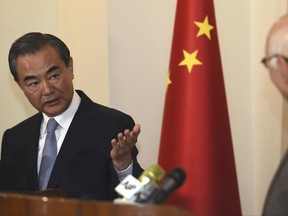 Visiting Chinese Foreign Minister Wang Yi, left, gestures to Pakistan's adviser on foreign affairs Sartaj Aziz during a press conference, in Rawalpindi, Pakistan, Sunday, June 25, 2017. China's foreign minister says Beijing will hold a dialogue with Afghanistan and Pakistan to help improve relations between the two South Asian neighbors. (AP Photo/Anjum Naveed)