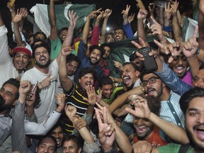 Pakistani cricket fans celebrate their team's victory in the Champions Trophy final against India, at a street in Lahore, Pakistan. Sunday, June 18, 2017. (AP Photo/K.M. Chaudary)