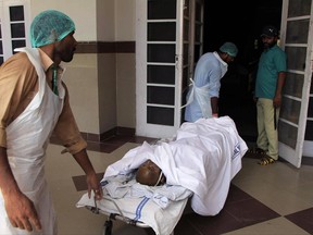 Pakistani hospital staff transport a victim of an oil tanker explosion at a hospital in Multan, Pakistan, Sunday, June 25, 2017. An overturned oil tanker burst into flames in Pakistan on Sunday, killing scores of people who had rushed to the scene of the highway accident to gather leaking fuel, an official said. (AP Photo/Adeel Khan)