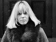 24th October 1968:  Italian-born German actress Anita Pallenberg sits cross-legged on a flight of stone steps with her hands in her pockets.  (Photo by Larry Ellis/Express/Getty Images)