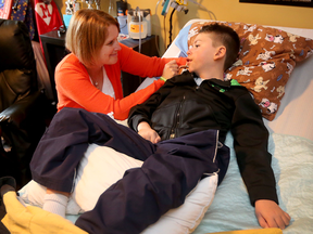 Stephanie Paravan of Ottawa tends to her son Matthew, 10, who suffers from a debilitating neurological condition. She hopes an alliance alleviates the burden on parents in ensuring correct information is shared between centres.