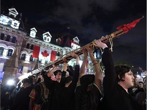 People hold a teepee, intended to be erected on Parliament Hill as part of a four-day Canada Day protest during a demonstration in Ottawa on Thursday, June 29, 2017. THE CANADIAN PRESS/Justin Tang ORG XMIT: JDT103