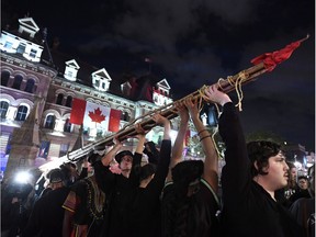 People hold a teepee, intended to be erected on Parliament Hill as part of a four-day Canada Day protest during a demonstration in Ottawa