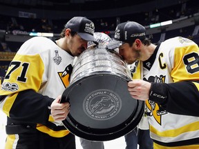 Evgeni Malkin (L) led the playoffs with 28 points, while Sidney Crosby (R), who won his second straight Conn Smythe Trophy, was second with 27 points.