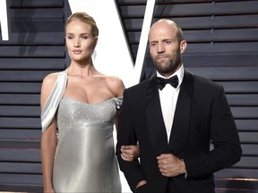 FILE - In this Feb. 26, 2017 file photo, Rosie Huntington-Whiteley, left, and Jason Statham arrive at the Vanity Fair Oscar Party in Beverly Hills, Calif. Huntington-Whiteley and her fiancé Statham welcomed son Jack Oscar Statham, born on June 24 weighing 8.8 pounds. She announced the birth and included a photo in an Instagram post on Wednesday, June 28. (Photo by Evan Agostini/Invision/AP, File)