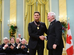 Governor General David Johnston presents Michael Buble with the National Arts Centre Award during the Governor General's Performing Arts Awards ceremony at Rideau Hall in Ottawa on Wednesday, June 28, 2017.