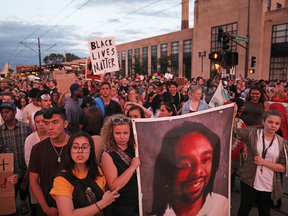 Protesters hold a photo of Philando Castile as they march in St. Paul, Minn., on Friday, June 16, 2017, after police Officer Jeronimo Yanez was cleared of all charges in Castile's fatal shooting last year.