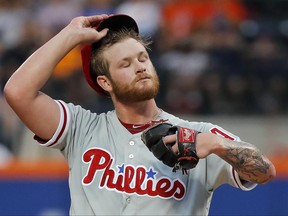 Philadelphia Phillies pitcher Ben Lively adjusts his cap after walking New York Mets' Jay Bruce to load the bases during the first inning of a baseball game, Friday, June 30, 2017, in New York. (AP Photo/Julie Jacobson)