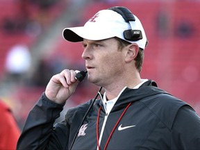 FILE  - In this Saturday, Dec. 17, 2016 file photo, Houston coach Major Applewhite looks on during the second half of the Las Vegas Bowl NCAA college football game against San Diego State in Las Vegas. There is little incentive for teams outside the Power Five conferences _ the so-called Group of Five conferences _ to load up on games against each other. Quite literally, it does not pay enough for these schools to play. Major Applewhite takes over for Tom Herman in Houston and his first game could be tricky. Texas-San Antonio played in a bowl game for the first time last season. (AP Photo/David Becker, File)