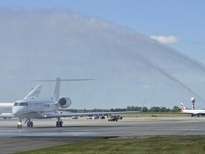 The first new jet for Poland's government officials, U.S. made Gulfstream G550, is being welcomed with a water cannon salute as it lands at the military airport, in Warsaw, Poland, Wednesday, June 21, 2017. Since early 1990s Poland has been planning to buy new planes for VIP's to replace Soviet made aircrafts. (AP Photo/Alik Keplicz)