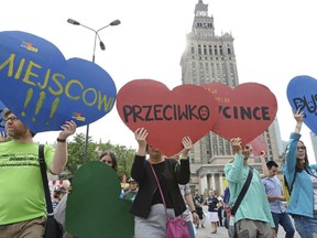 Protesters march demanding a stop to massive logging in the Bialowieza forest, one of Europe's last virgin woodlands, in Warsaw, Poland, Saturday, June 24, 2017, with placards reading Locals Against Logging.  The ruling Law and Justice party has allowed increased logging in Bialowieza, a vast woodland that straddles Poland and Belarus, alarming environmentalists who say it threatens a natural treasure.(AP Photo/Alik Keplicz)