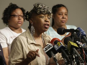 FILE- In this July 14, 2015, file photo, Eric Garner's mother Gwen Carr, center, is joined by his daughter Emerald Snipes, left, and wife Esaw Snipes, as she speaks during a news conference in New York. The family of Eric Garner, an unarmed black man killed by a police chokehold, is set to meet with Department of Justice officials with the outcome of the high-profile federal investigation of the case still unknown, the department confirmed Tuesday, June 20, 2017. (AP Photo/Mary Altaffer, File)