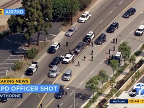 This image from video provided by KABC-TV shows the scene where a Los Angeles police officer was shot following the pursuit of a homicide suspect ending in El Segundo, Calif., on the border of neighboring Hawthorne, Thursday, June 29, 2017. Officials say the suspect was being pursued by a multi-agency task force but couldn't immediately provide additional details. Los Angeles Police Chief Charlie Beck said the officer was wounded in the hip and will recover. The suspect was also shot and wounded. (KABC-TV via AP)