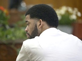 Dominique Heaggan-Brown listens to the statement he made to investigators after the shooting is read back to him in court by Special Agent Raymond Gibbs of the Wisconsin Department of Justice, Friday, June 16, 2017, in Milwaukee. Heaggan-Brown, a former Milwaukee police officer on trial in a fatal shooting that sparked riots in a predominantly black neighborhood, said Friday he will not testify, as his attorneys prepare to begin presenting his defense. (Michael Sears/Milwaukee Journal Sentinel via AP, Pool)