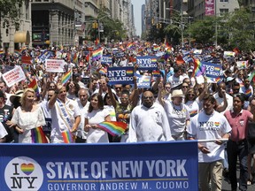 FILE- In this June 26, 2016 file photo, marchers filled the street during New York City's pride parade. The annual pride parade takes place on Sunday, June 25, 2017, amid protests by black and brown LGBT people saying increasingly corporate pride celebrations prioritize the experiences of gay white men and ignore the issues continuing to face black and brown LGBT people. (AP Photo/Mel Evans, File)