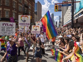 People march during the annual Toronto Pride Parade on Sunday, July 3, 2016.