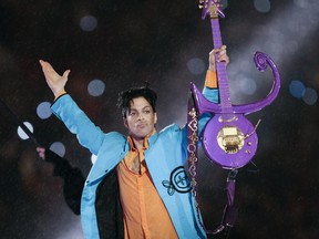 FILE - In this Feb. 4, 2007 file photo, Prince performs during the halftime show of the Super Bowl XLI football game at Dolphin Stadium in Miami. Lawyers for Universal Music Group have renewed their request that a Minnesota judge cancel the company's music rights deal with Prince's estate, saying UMG will otherwise have to sue according to a court filing made public Tuesday, June 27, 2017. (AP Photo/Chris O'Meara, File)