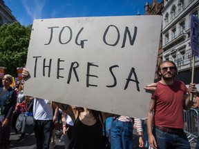 Demonstrators protest Theresa May's DUP coalition outside Downing Street on Saturday, June 10, 2017.