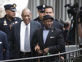 Bill Cosby, center left, accompanied by Joe Torry, center right walks from the Montgomery County Courthouse during his sexual assault trial in Norristown, Pa., Thursday, June 8, 2017.