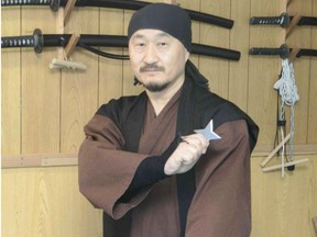 Masaaki Ikebe poses with a ninja star.