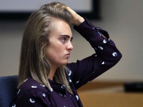 Michelle Carter adjusts her hair while her legal team approaches the bench for a sidebar discussion at Taunton District Court in Taunton, Mass., Thursday, June 8, 2017, during her trial for involuntary manslaughter.