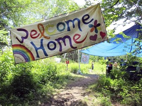 FILE--In this June 28, 2016, file photo, a sign welcomes people to the gathering of the Rainbow Family of Living Light in Mount Tabor, Vt. Federal prosecutors and judges are setting up a temporary court in remote eastern Oregon to handle citations against any attendees at the Rainbow Family of Living Light annual counter-culture gathering. The get-together in the Malheur National Forest set to begin later this week is expected to attract up to 20,000 campers and has already created tensions in this rural community. (AP Photo/Wilson Ring, file)