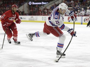 FILE - In this March 9, 2017, file photo, New York Rangers' Derek Stepan (21) shoots as Carolina Hurricanes' Jordan Staal (11) watches during the first period of an NHL hockey game in Raleigh, N.C. The Arizona Coyotes have acquired center Derek Stepan and goalie Antti Raanta from the New York Rangers, Friday, June 23, 2017,  for defenseman Anthony DeAngelo and the seventh overall pick in this year's draft. (AP Photo/Gerry Broome, File)