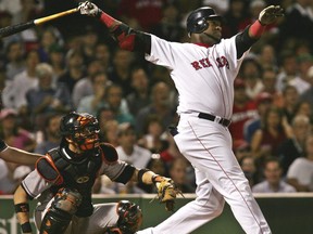 FILE - In this Sept. 22, 2004, file photo, Boston Red Sox's David Ortiz watches the flight of his two run, home run off Baltimore Orioles starter Sidney Ponson, in the seventh inning at Fenway Park in Boston. The Red Sox prepare to honor Ortiz, retiring the No. 34 worn by "Big Papi" when he led the once-cursed franchise to three World Series titles. The ceremony is Friday night, June 23, 2017.  (AP Photo/Charles Krupa, File)