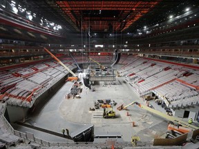 File--In this June 12, 2017 file photo, construction continues on Little Caesars Arena in Detroit.. A federal judge has denied a request to block some public funding for Little Caesars Arena and the Detroit Pistons' move from the suburbs. The arena scheduled to open in September will be home to the NHL hockey Detroit Red Wings and NBA basketball Detroit Pistons. (AP Photo/Paul Sancya)