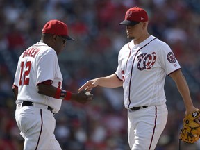 Washington Nationals relief pitcher Joe Blanton, right, is pulled from the game by manager Dusty Baker (12) during the ninth inning of a baseball game against the Cincinnati Reds, Sunday, June 25, 2017, in Washington.  (AP Photo/Nick Wass)