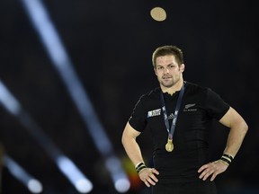 New Zealand's flanker and captain Richie McCaw celebrates with his gold medal after winning  the final match of the 2015 Rugby World Cup between New Zealand and Australia at Twickenham stadium, south west London, on October 31, 2015.