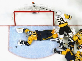 Goaltender Pekka Rinne of the Nashville Predators robs Pittsburgh Penguins'  Jake Guentzel from close in during Game 4 action in the Stanley Cup Final Monday in Nashville. Rinne was a standout with 23 saves as the Preds posted a 4-1 victory to tie the best-of-seven 2-2 heading to Pittsburgh for Game 5 on Thursday.