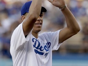 Los Angeles Lakers draft pick Lonzo Ball throws out the first pitch before a baseball game between the Los Angeles Dodgers and the Colorado Rockies in Los Angeles, Friday, June 23, 2017. (AP Photo/Chris Carlson)