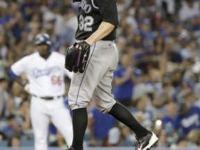 Colorado Rockies starting pitcher Tyler Chatwood reacts after walking in Los Angeles Dodgers' Yasmani Grandal for a run during the third inning of a baseball game in Los Angeles, Saturday, June 24, 2017. (AP Photo/Chris Carlson)