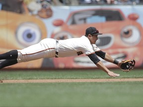 San Francisco Giants third baseman Jae-Gyun Hwang (1), of South Korea, cannot reach a base hit by Colorado Rockies' Trevor Story during the third inning of a baseball game in San Francisco, Wednesday, June 28, 2017. (AP Photo/Jeff Chiu)